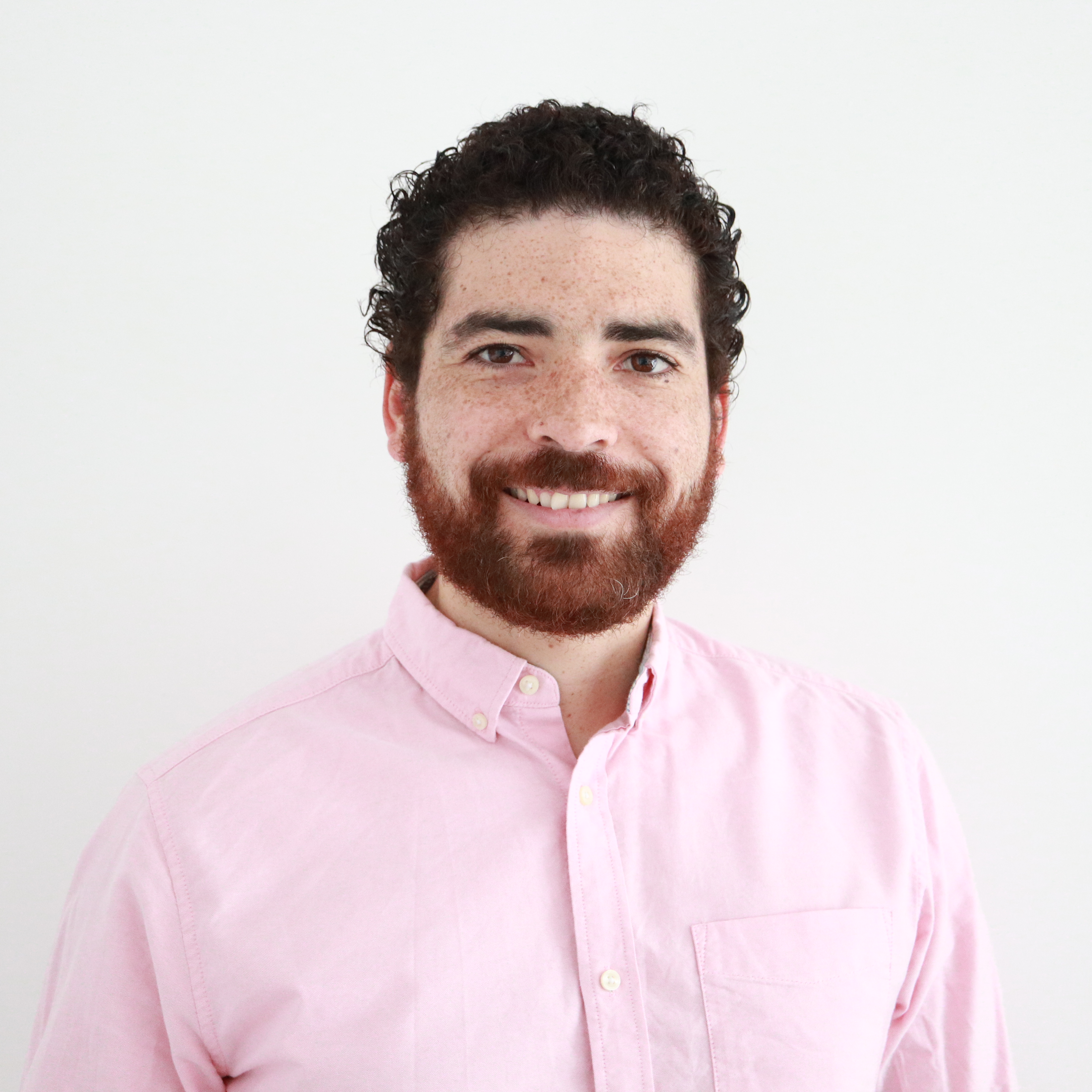 My personal profile photo: in this photo you can see myself smilling and wearing a pink long sleeve shirt with a white background
